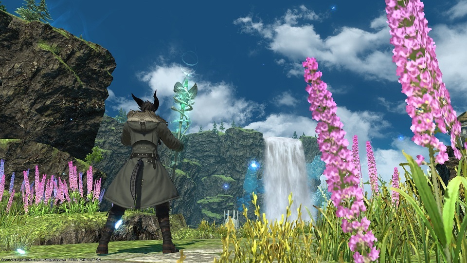 The Warrior of Light set against fair skies, greenery, pink flowers, and a far-off waterfall